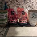 Four gardening products arranged on a kitchen counter, including BuildASoil bloom booster and V-K dry soluble fertilizers in red and green packaging