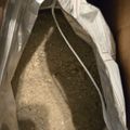 A clear plastic bag containing what appears to be a granular or powdery substance, with some text visible on a label attached to the bag.