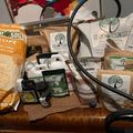 A collection of gardening and growing supplies from BuildASoil brand arranged on a wooden surface, including soil amendments, nutrients, and organic growing products in various packages and containers.