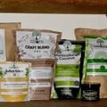 A shelf displaying various organic gardening and soil products in packages and bags, including craft blend fertilizers, coconut-based growing medium, and other plant nutrients from BuildASoil.com